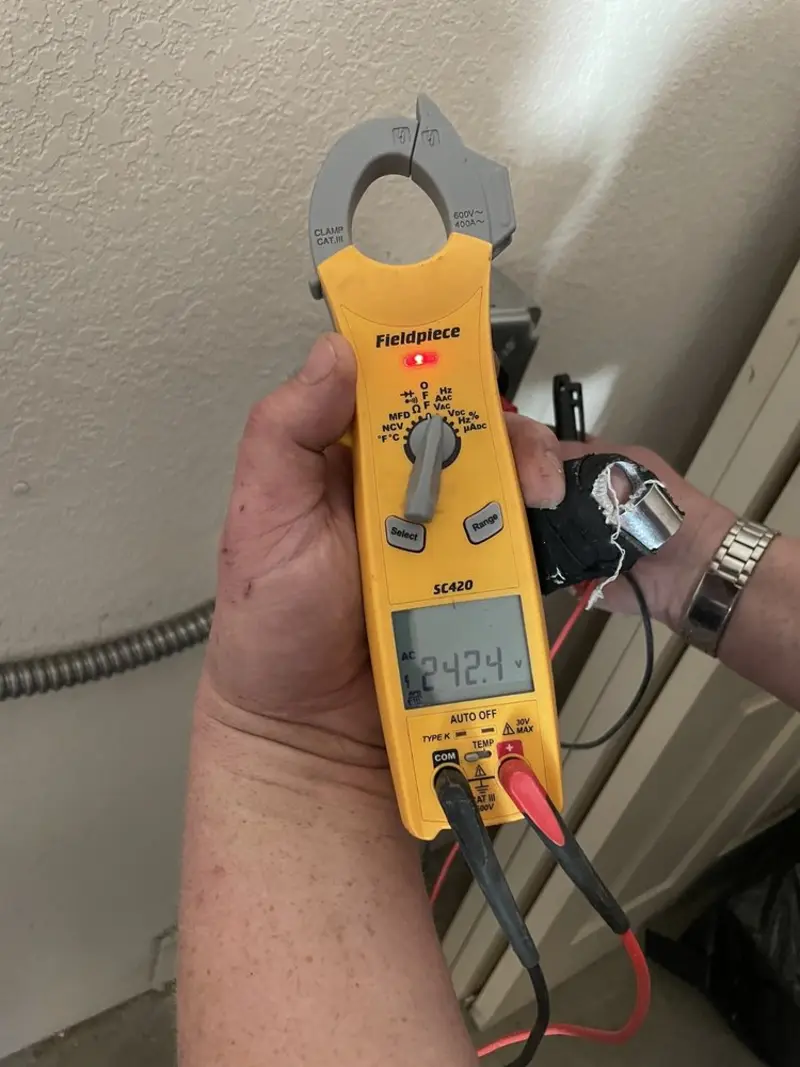 Voltage testing with clamp meter during Recessed Lighting Installation in Jerome